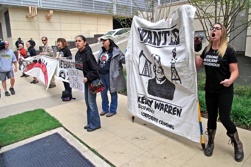 Garett Maupin (right) of Fort Worth protested with others outside an Energy Transfer...