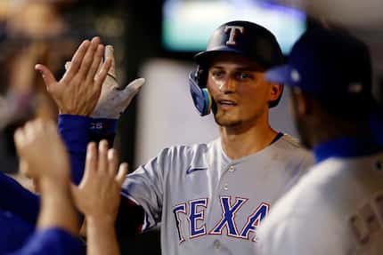 Texas Rangers' Corey Seager is congratulated for his home run against the New York Mets...