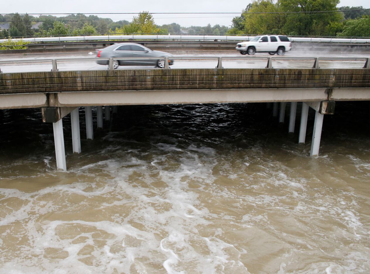 Cars make their way southbound on Garland Road near White Rock Lake spillway in Dallas on...