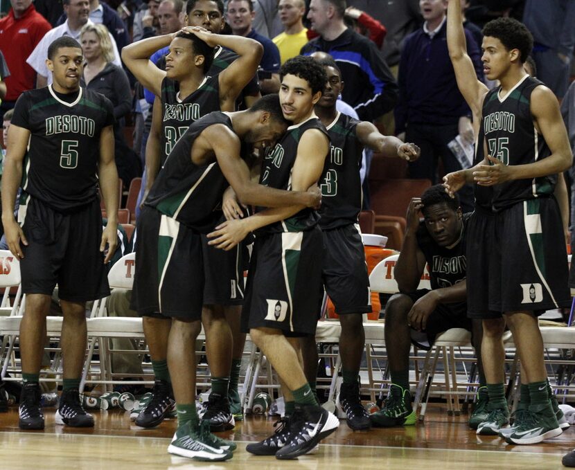 The Desoto team reacts as guard Takedrick Brown (11) hugs teammate Julian Miranda (2) after...