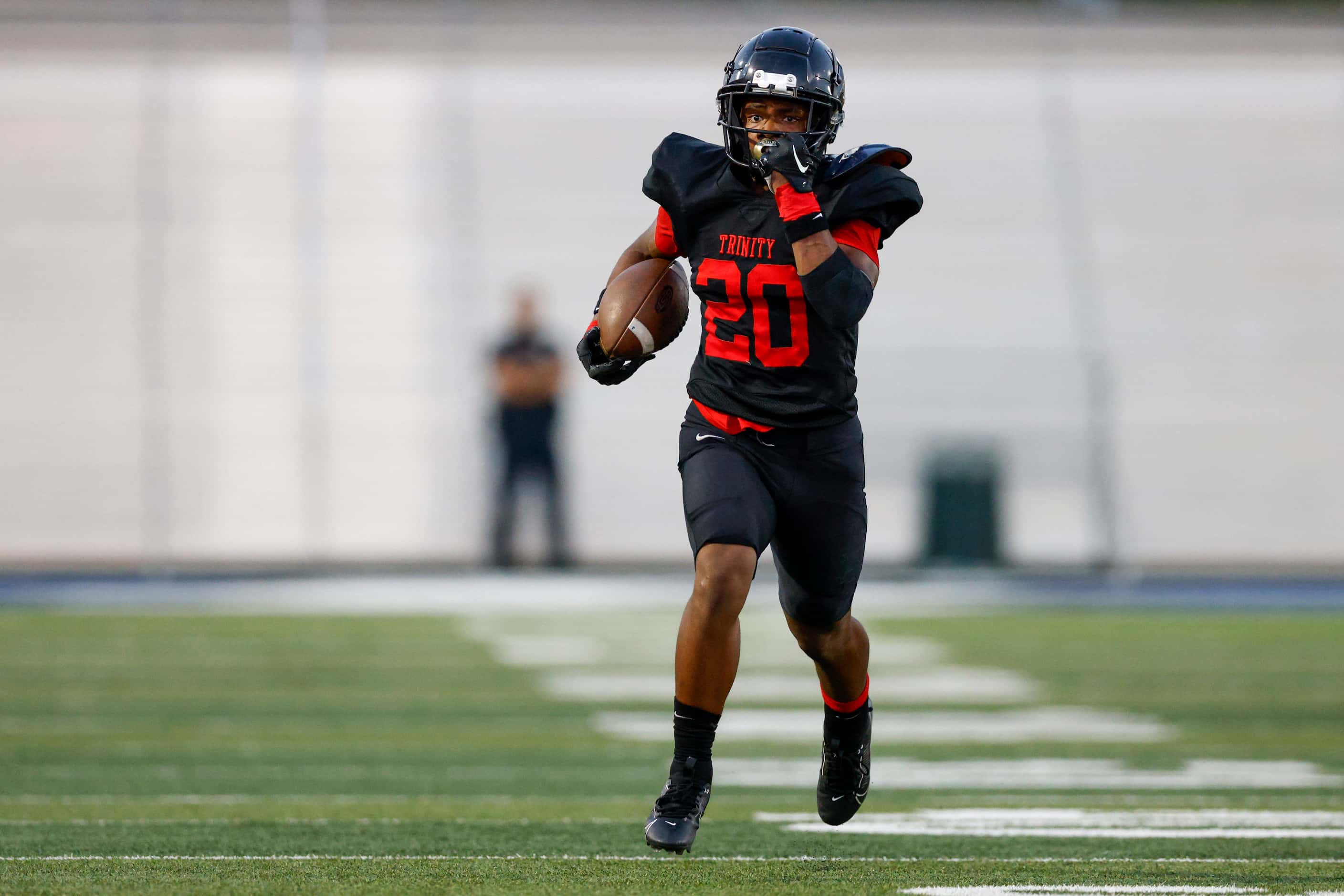Euless Trinity running back Josh Bell (20) runs for a 73 yard touchdown during the first...