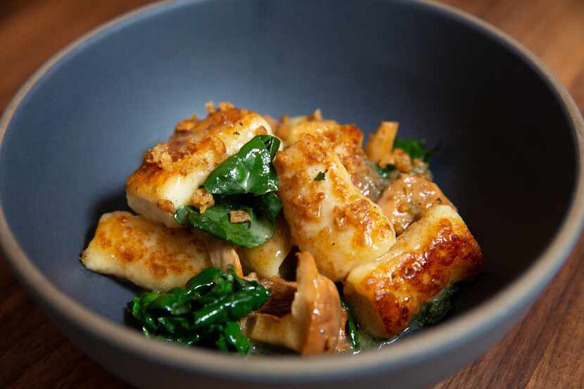 Ricotta gnocchi with chanterelles, kale and charred onion vinaigrette