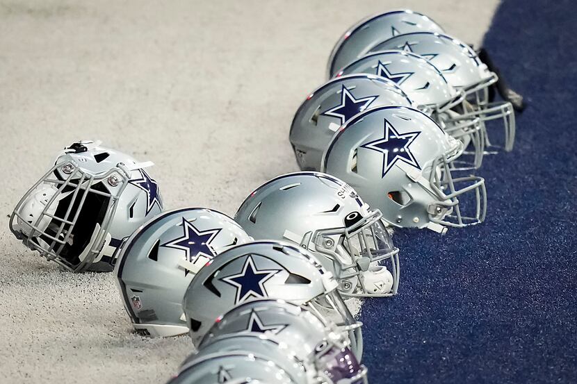 Dallas Cowboys players’ helmets rest in the end zone during the team's OTA practice at The...