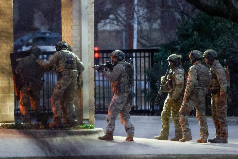 Members of the FBI stood outside while conducting SWAT operations at Congregation Beth...