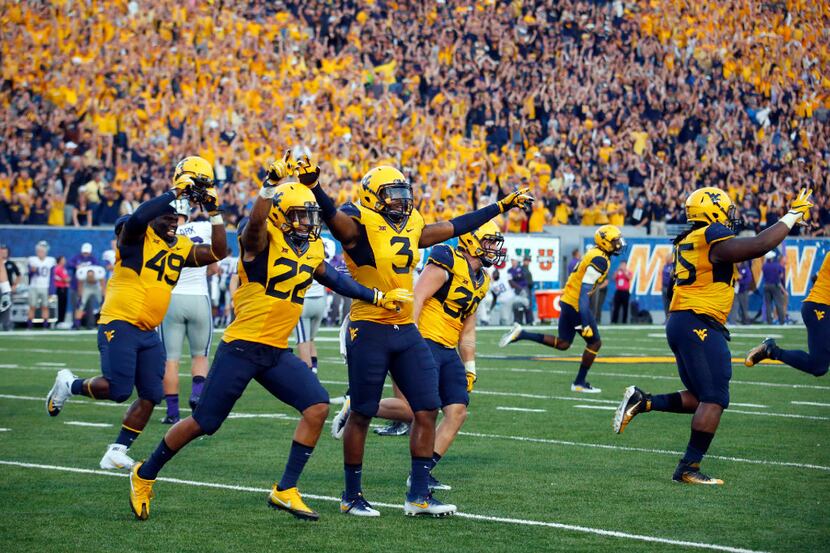 MORGANTOWN, WV - OCTOBER 01:  The West Virginia Mountaineers celebrate after the Kansas...