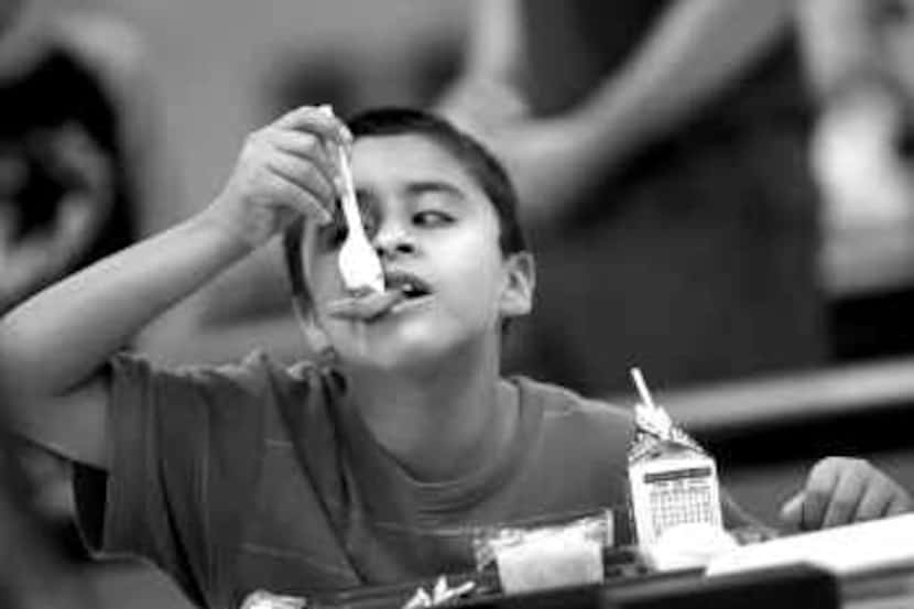  Bryan Albarran, who will be in fourth grade this fall, eats lunch at Irving's Good...