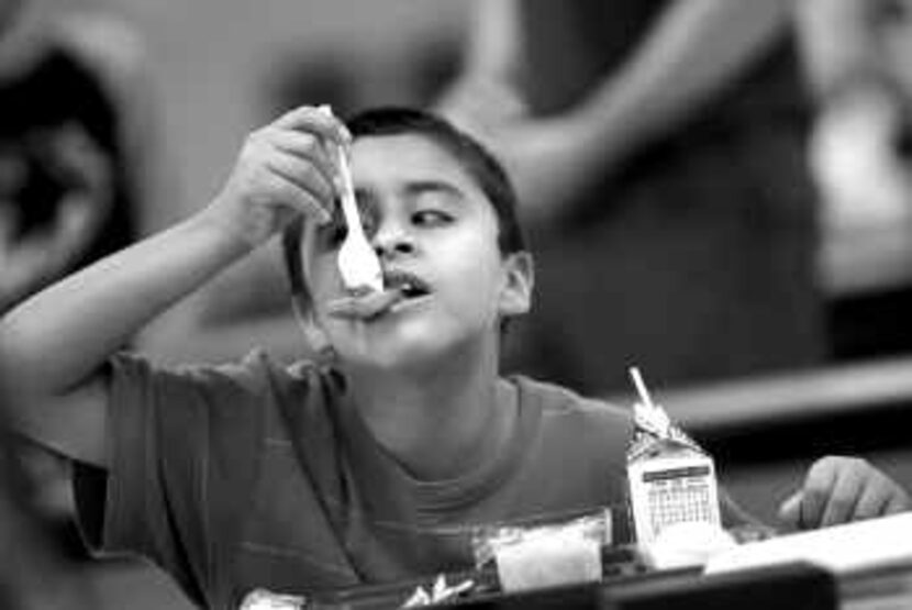  Bryan Albarran, who will be in fourth grade this fall, eats lunch at Irving's Good...