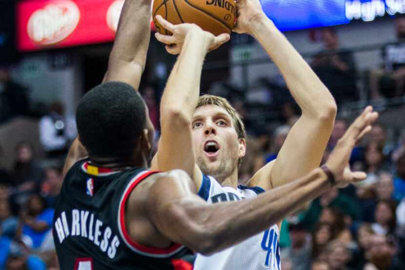 Dallas Mavericks forward Dirk Nowitzki (41) goes up for a shot over Portland Trail Blazers...
