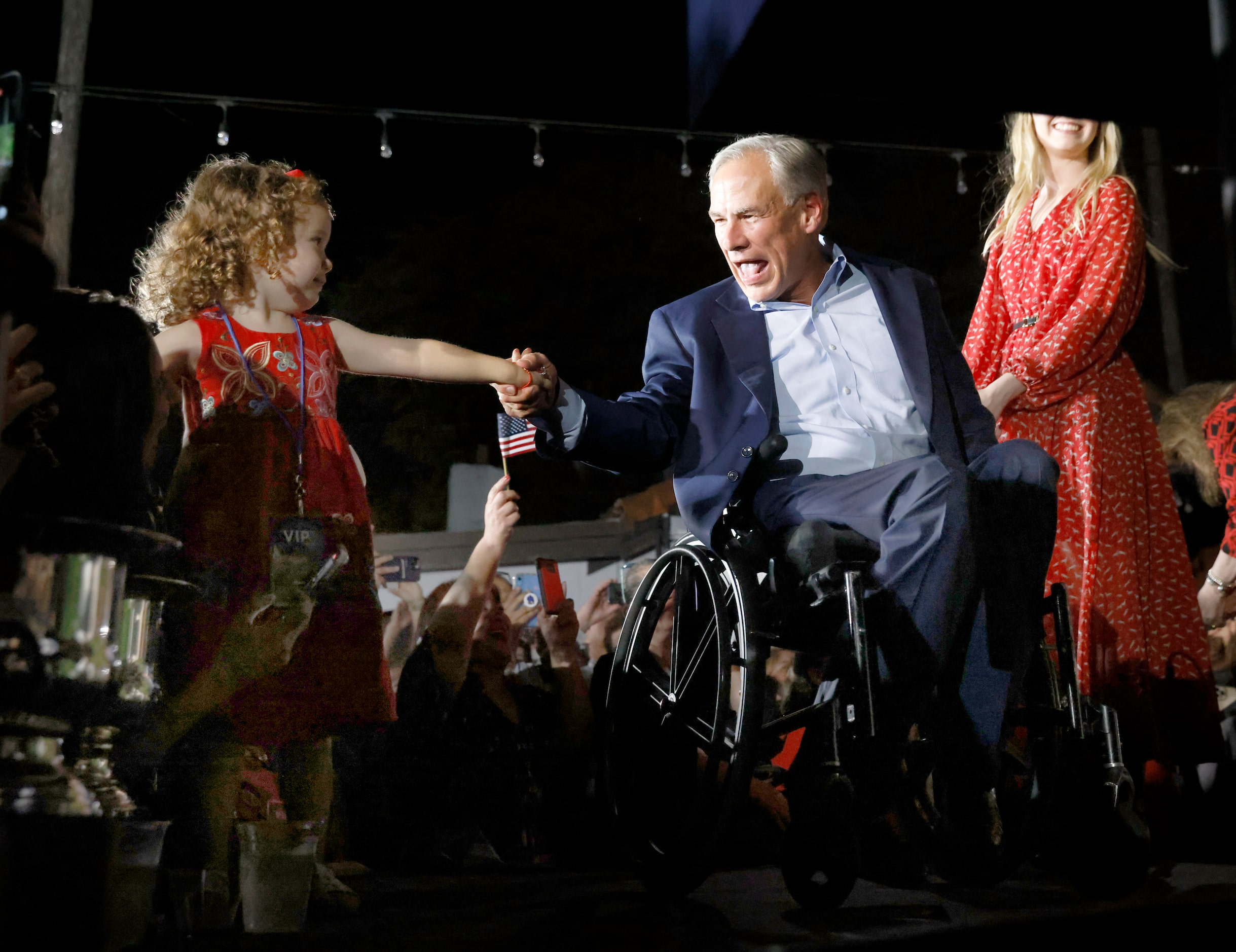 Texas Governor Greg Abbott shakes with a young supporter as he arrives to make his victory...