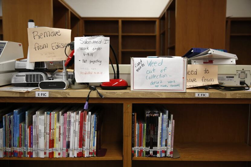 Broken equipment and empty book shelves in the library at Thomas A. Edison Middle Learning...