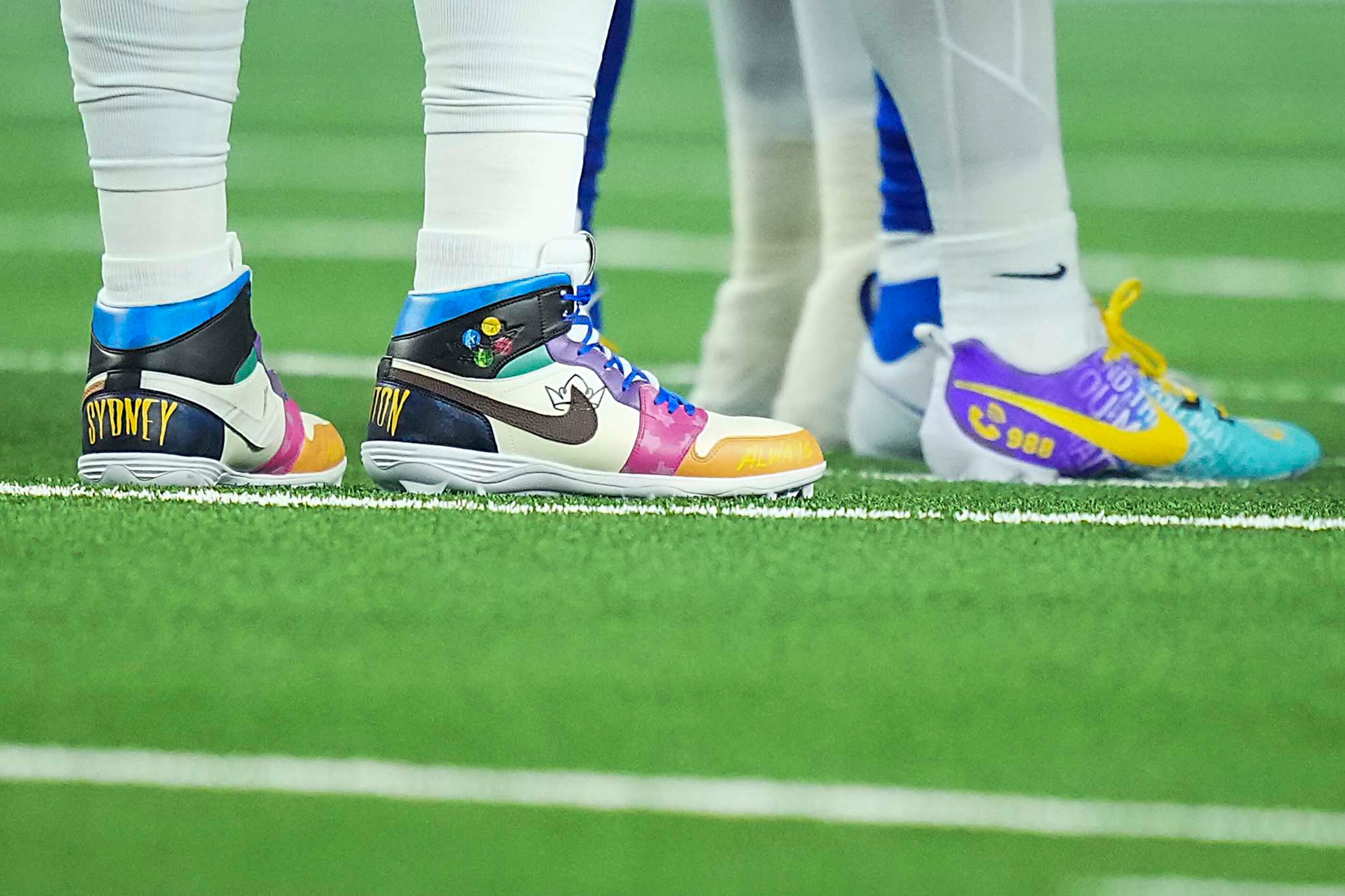 Dallas Cowboys quarterback Dak Prescott’s cleats, at left, during the first quarter of an...