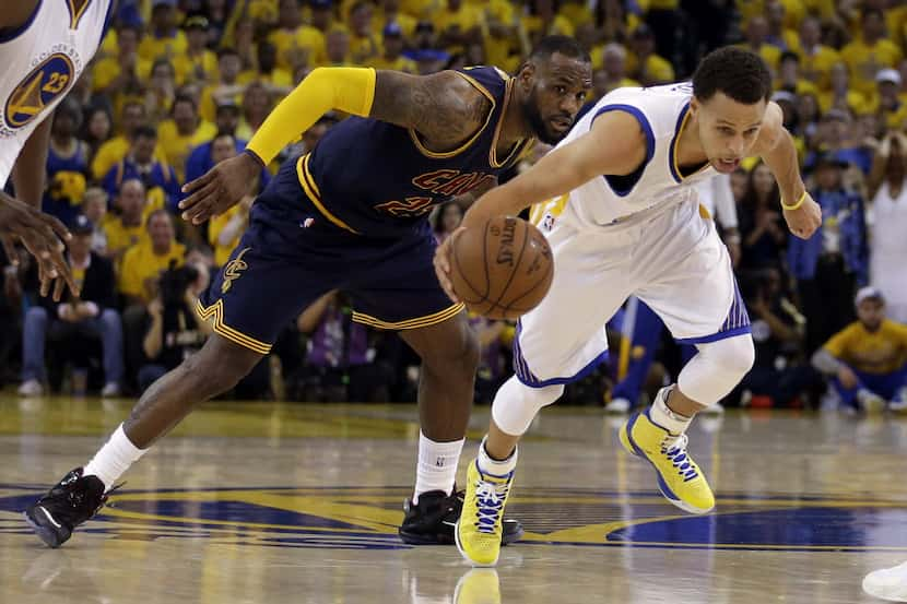 FILE- In this June 7, 2015 file photo, Cleveland Cavaliers forward LeBron James (23) watches...