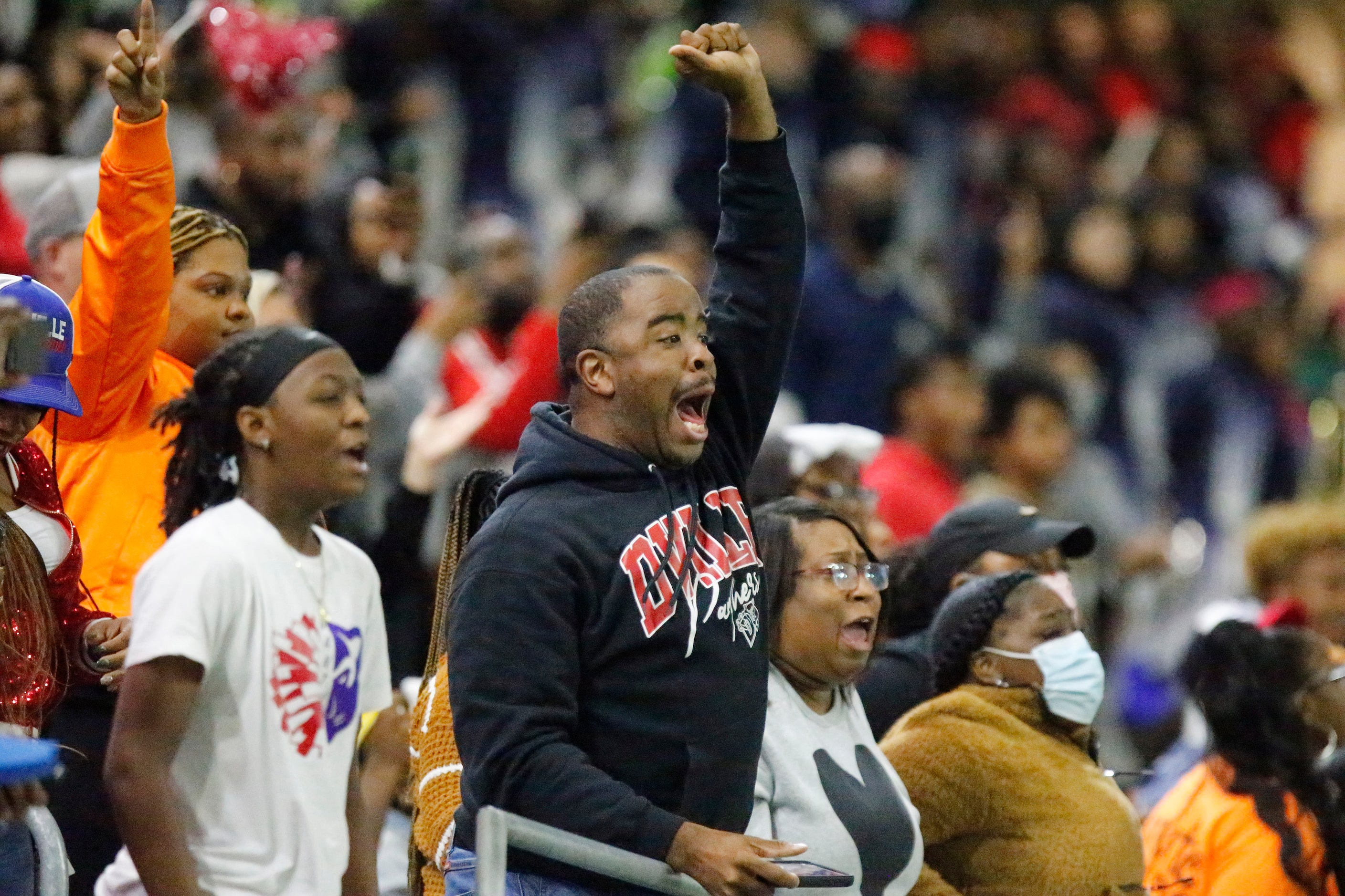 Duncanville resident Geoffrey Howard cheers for a big return on the opening kickoff as...