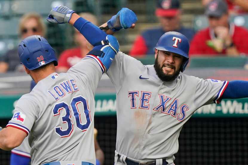 Texas Rangers' Isiah Kiner-Falefa, right, congratulates Nathaniel Lowe after Lowe hit a...