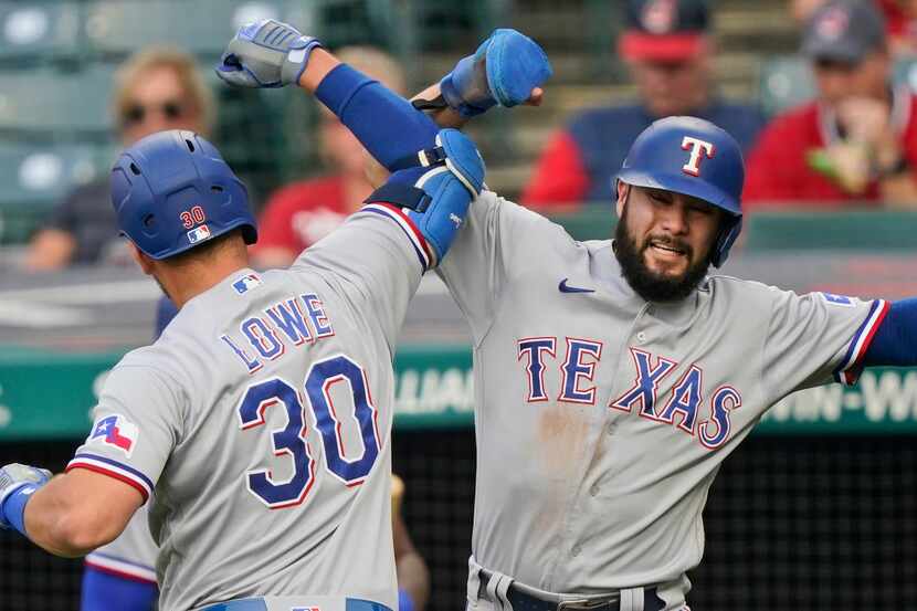 Texas Rangers' Isiah Kiner-Falefa, right, congratulates Nathaniel Lowe after Lowe hit a...
