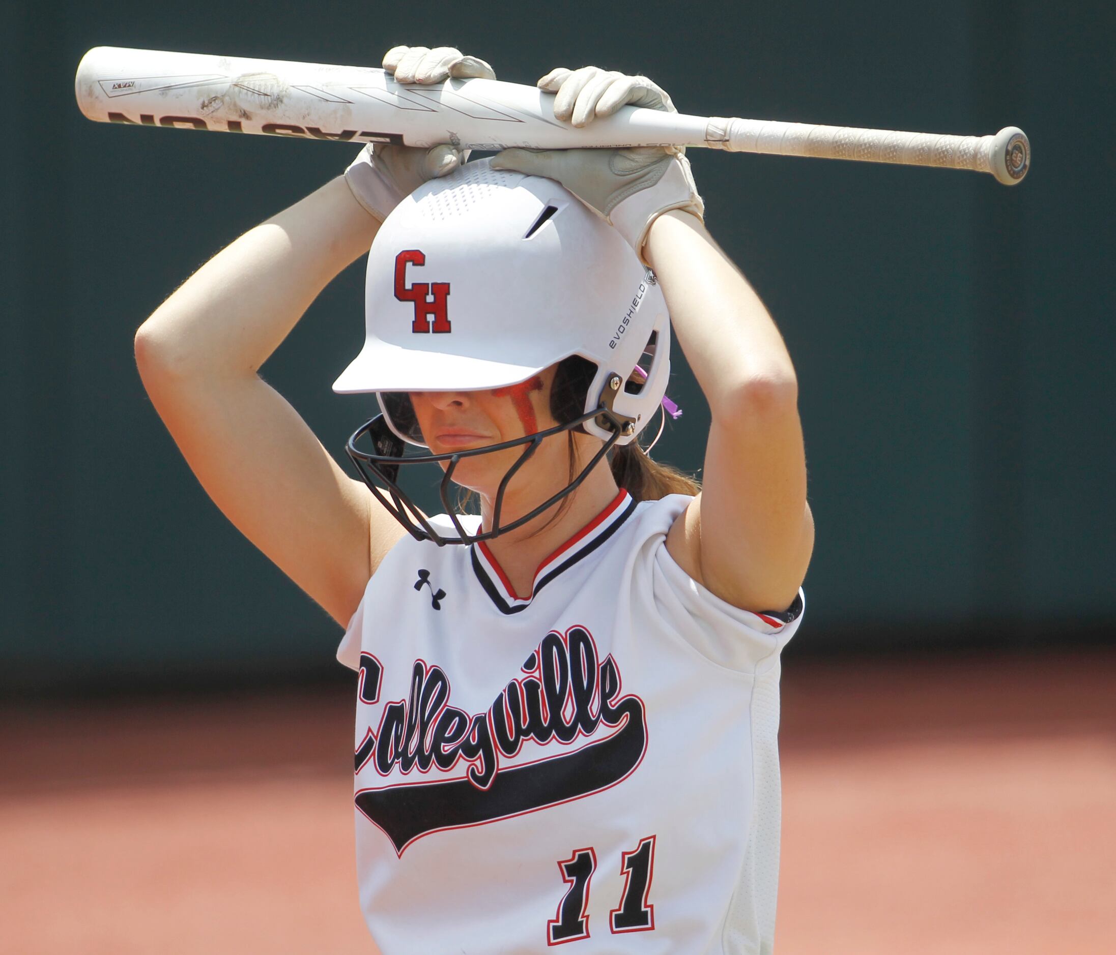 Colleyville Heritage third baseman Graci Green (11) returns to the dugout as the last batter...