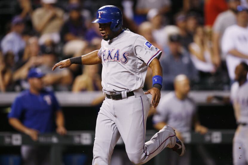 Texas Rangers' Elvis Andrus claps as he scores the go-ahead run on a double hit by Mitch...