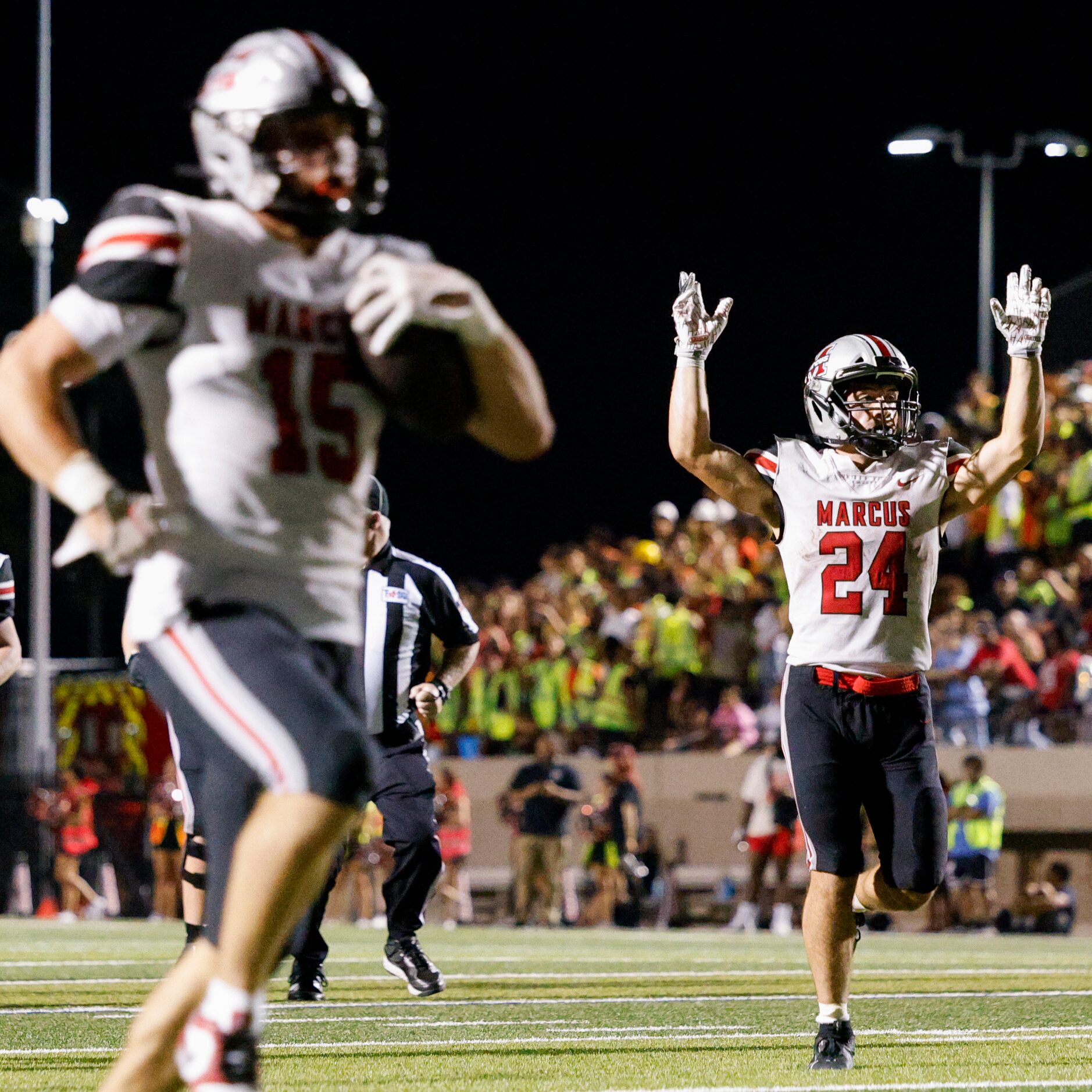 Flower Mound Marcus running back Isiah Keliikipi (24) celebrates a touchdown by quarterback...