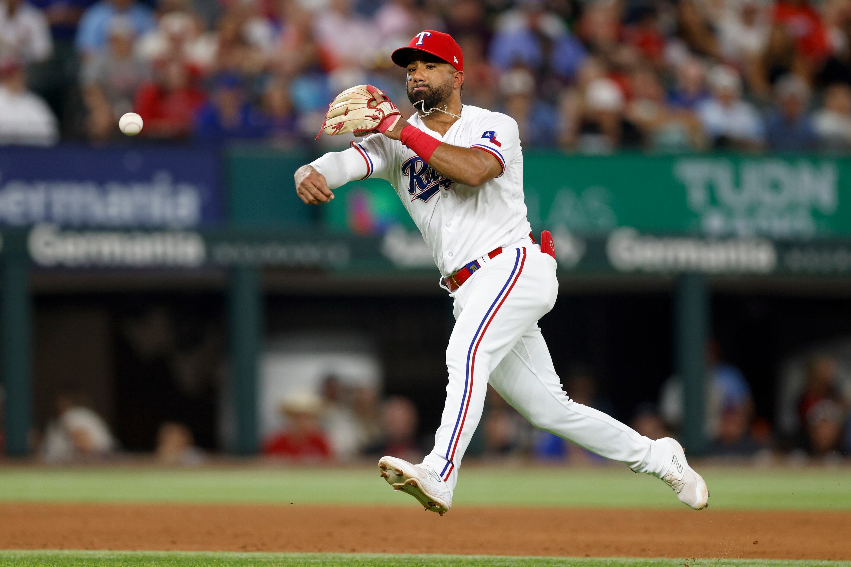 Marcus Semien of the Texas Rangers throws to first base in the