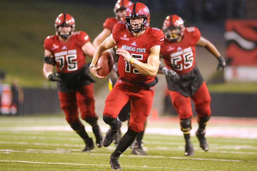 Arkansas State quarterback Justice Hansen carries the ball during the first half against...