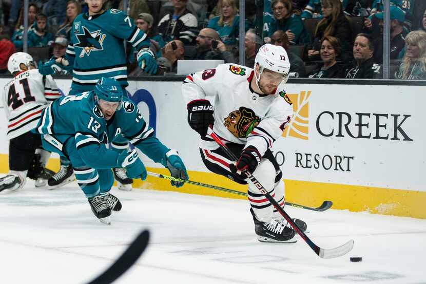 Chicago Blackhawks center Max Domi (13) gets possession of the puck from San Jose Sharks...