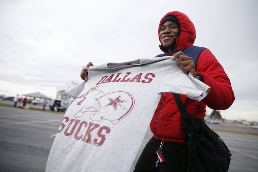 Omar Haughton, of Philadelphia, sells shirts to tailgaters that display the text "Dallas...