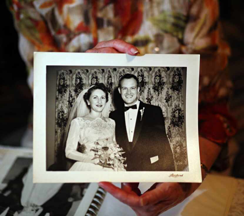 Ann Ticknor holds a photo taken of her and husband, Hal, at their wedding.
