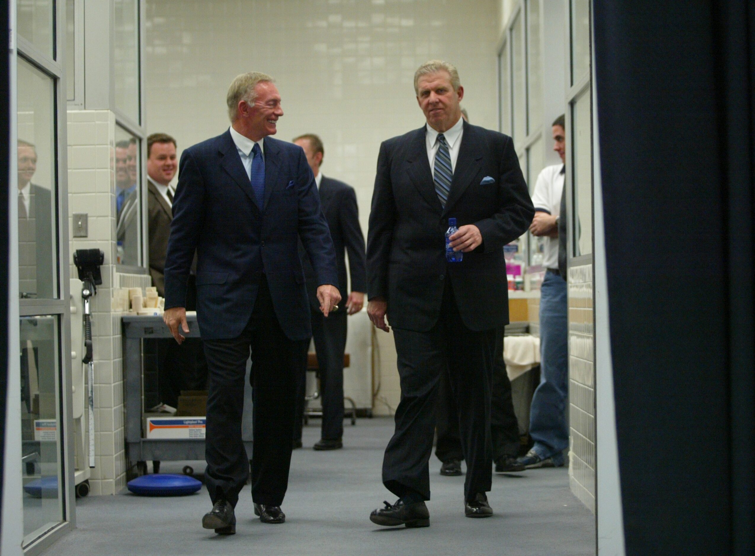 Dallas Cowboys owner Jerry Jones and new head coach Bill Parcells walk into the locker room...