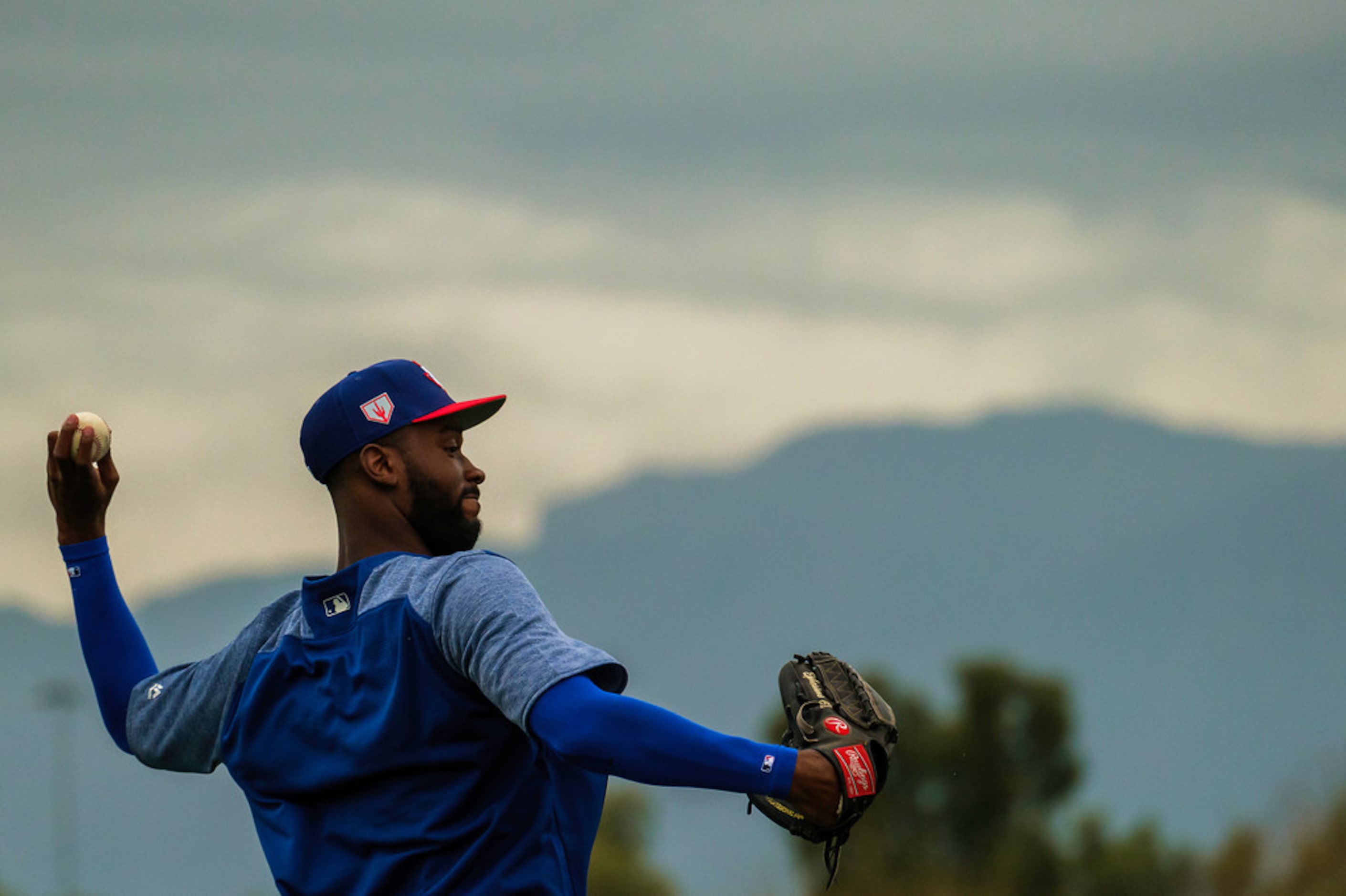 Texas Rangers pitcher Taylor Hearn throws long toss during a spring training workout at the...