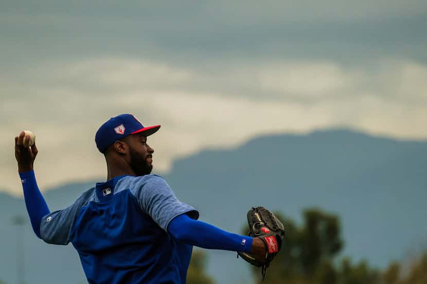 Texas Rangers pitcher Taylor Hearn throws long toss during a spring training workout at the...