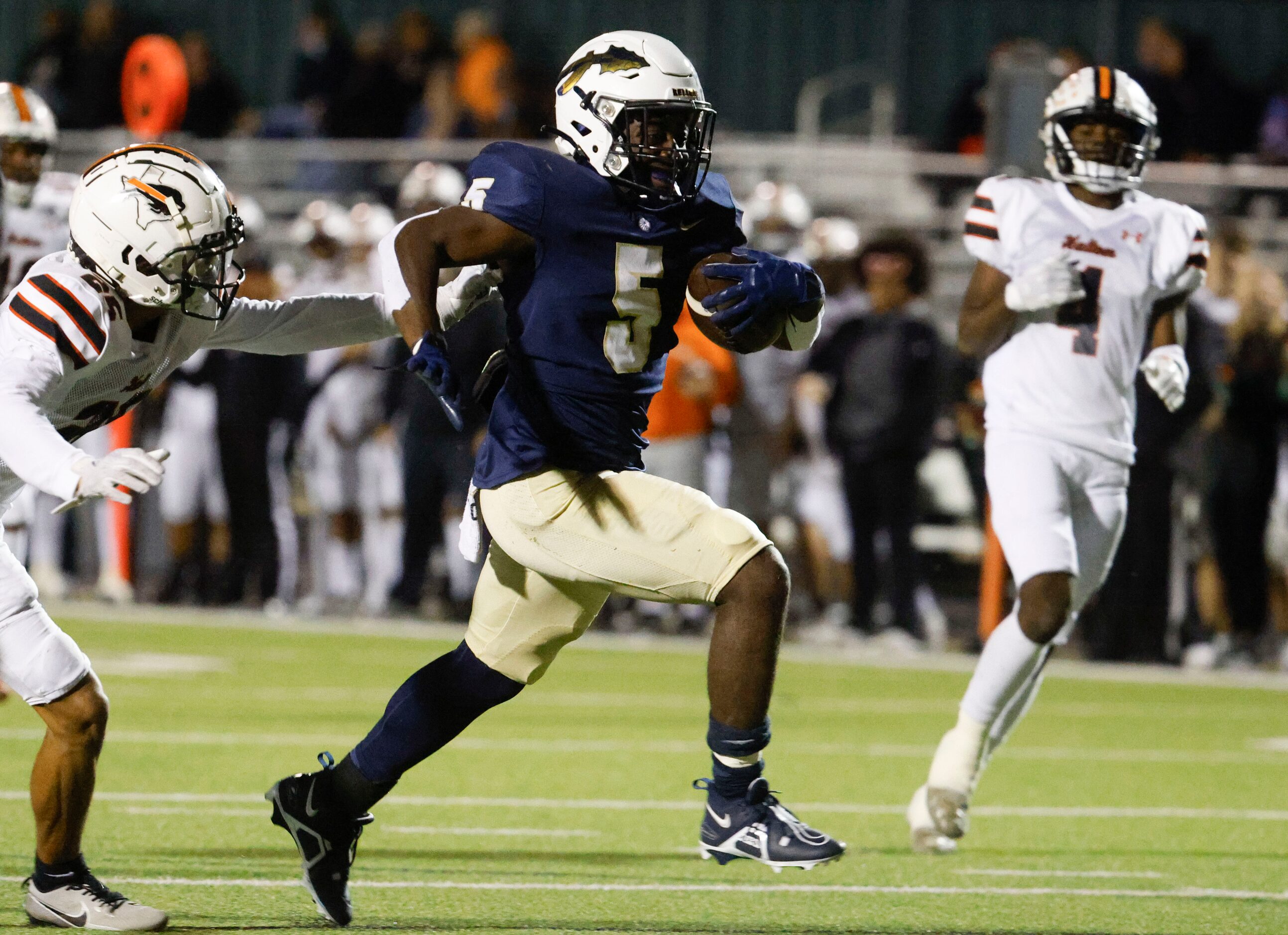 Keller High’s Cameron Rayford (5) runs past Haltom high’s Lukas Bryant (left) for a...