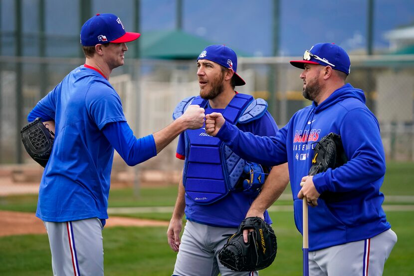 Texas Rangers pitcher Kyle Gibson (left) fist bumps Frisco manager Bobby Wilson after throw...