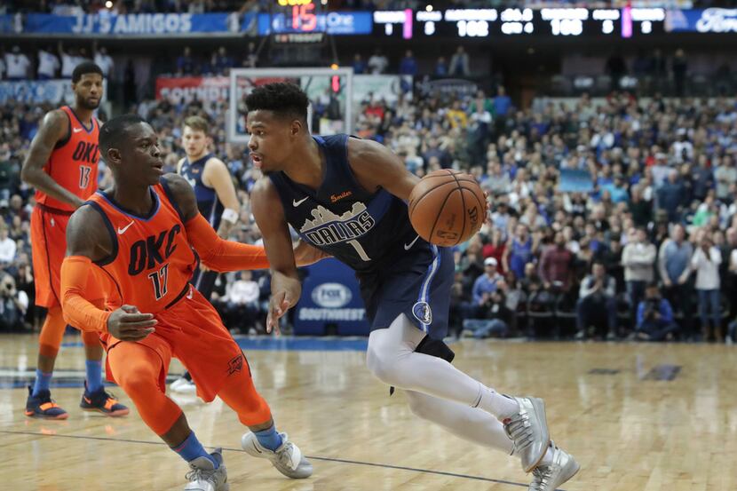 Mavericks guard Dennis Smith Jr. drives against Oklahoma City's Dennis Schroder Sunday...