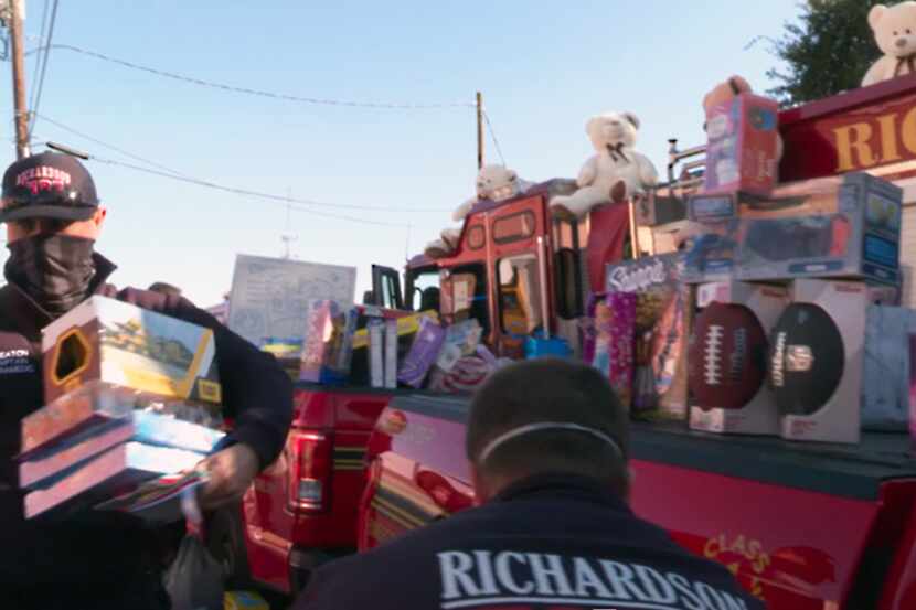 Richardson firefighters are shown delivering toys and canned food to the nonprofit group,...