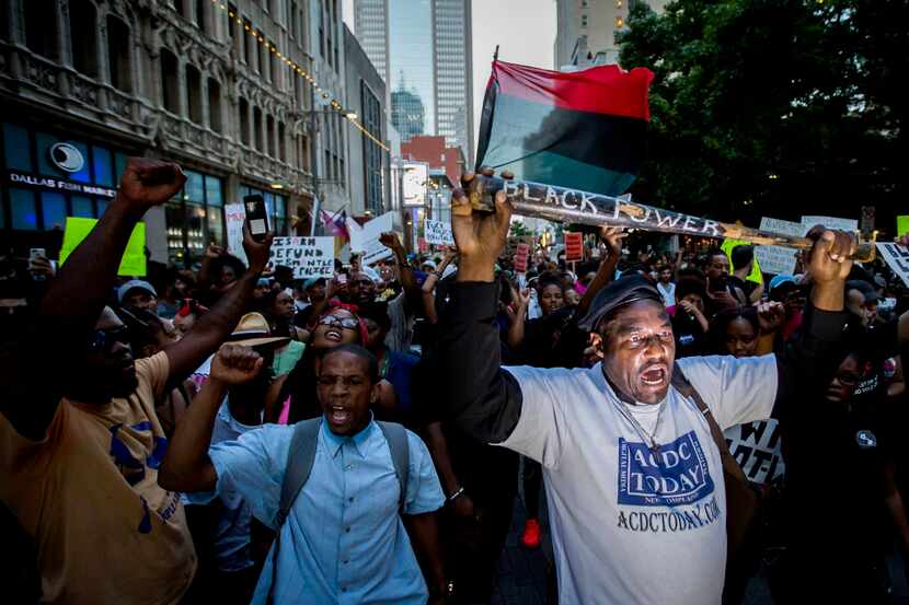 Ernest Walker leads other protestors at a rally in downtown Dallas on Thursday, July 7,...