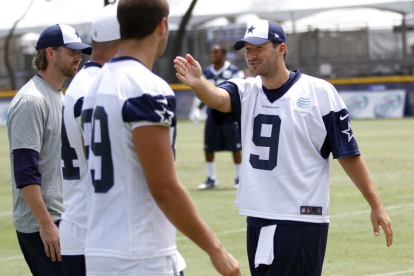 Dallas Cowboys quarterback Tony Romo (9) talks with Dallas Cowboys tight end James Hanna...