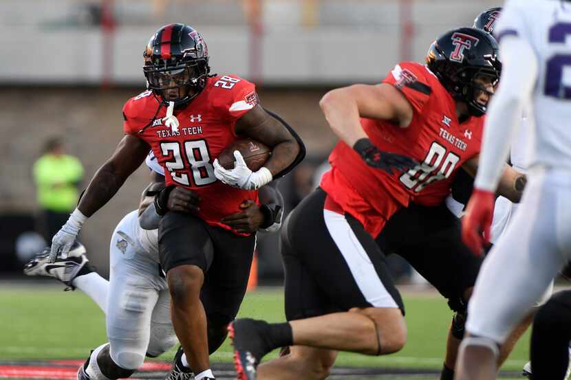 Texas Tech running back Tahj Brooks (28) carries against TCU during an NCAA college football...