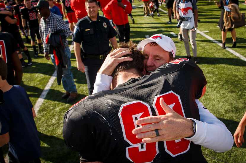 SMU head coach Chad Morris hugs defensive end Justin Lawler after a victory over Tulane in...