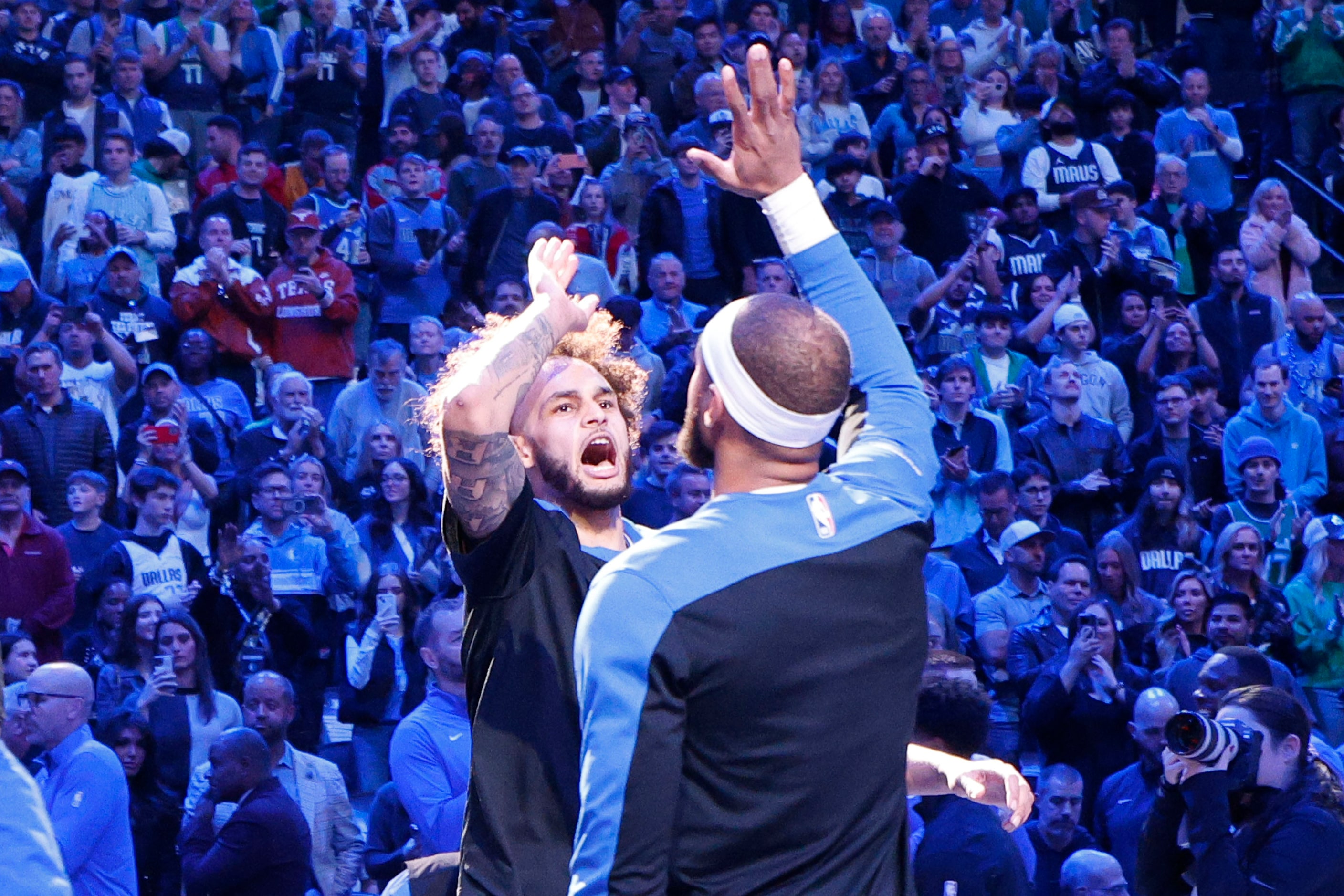 Dallas Mavericks center Dereck Lively II (2), face to camera, gets a high-five from his...