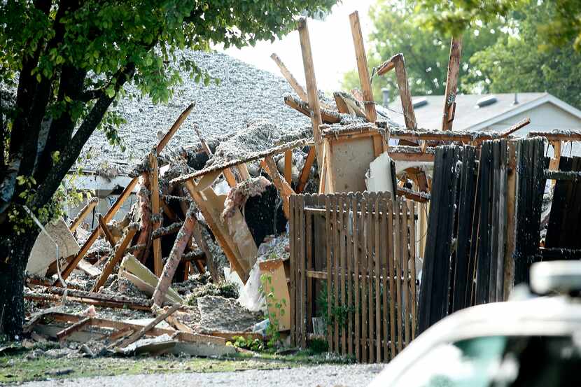 Debris was all that was left on the site of a home explosion Monday.