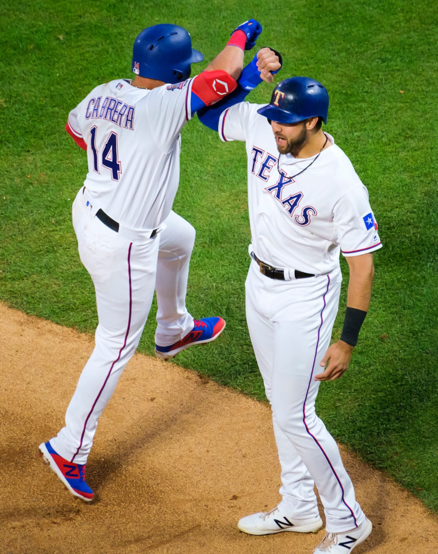 Texas Rangers third baseman Asdrubal Cabrera celebrates with Joey Gallo after hitting a...