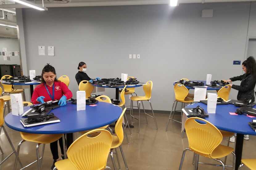 Teachers and staff at Legacy Preparatory Charter Academy in Mesquite sanitize computers and...