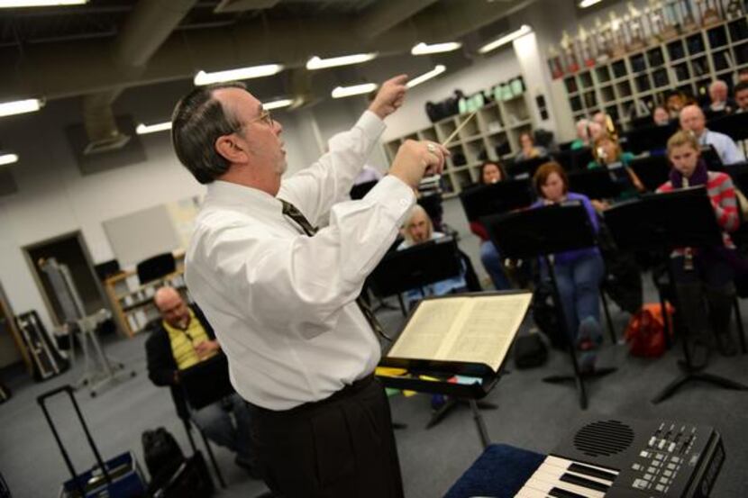 Jim McDaniel, conductor and artistic director, leads the Carrollton Wind Symphony members...