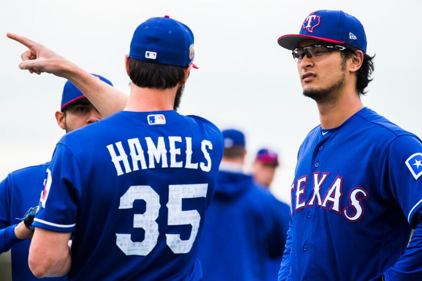 Texas Rangers starting pitcher Cole Hamels (35) talks with starting pitcher Martin Perez...