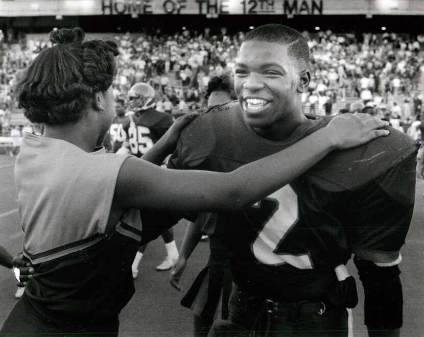 1988: Gary Edwards is congratulated by a cheerleader after a playoff game. Carter won 31-7,...