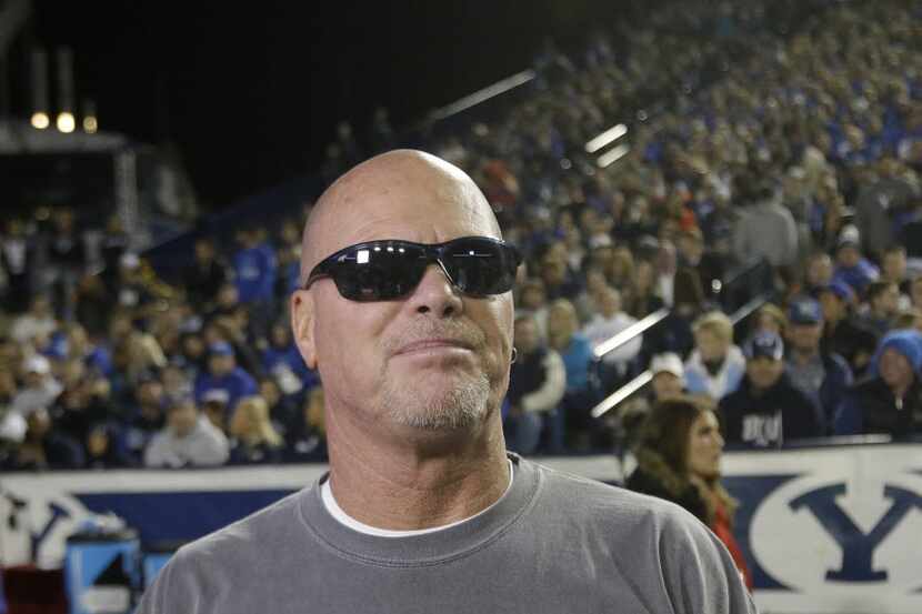 Former Brigham Young player Jim McMahon looks on before his No. 9 jersey went on permanent...