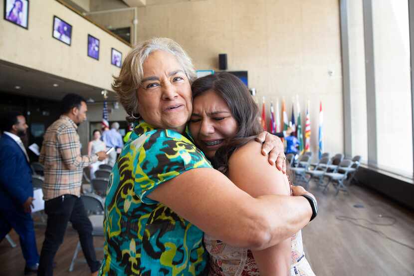 Rosa Hernandez-Razo, right, is embraced by Sarah Saldana, former Director of the U.S....