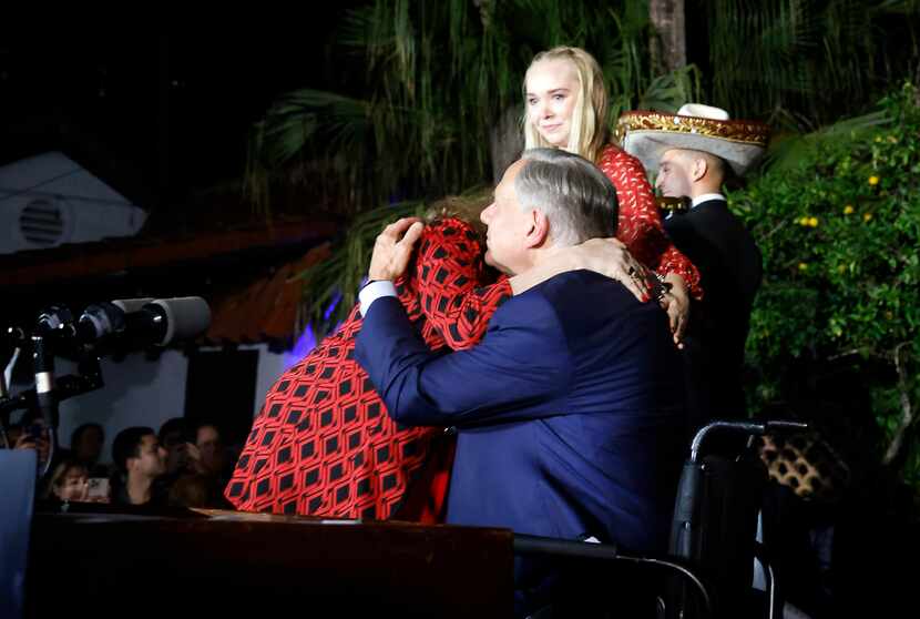 Texas Governor Greg Abbott receives a hug and kiss  from his wife Cecilia Abbott following a...
