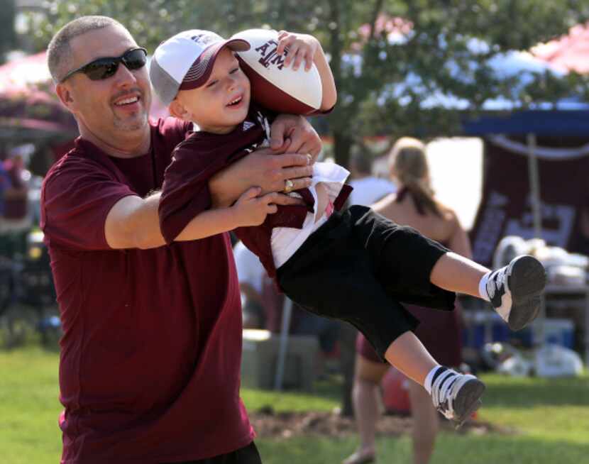 Jeff Puckett of College Station gave his 2-year-old son, Logan, a swing while they enjoyed...