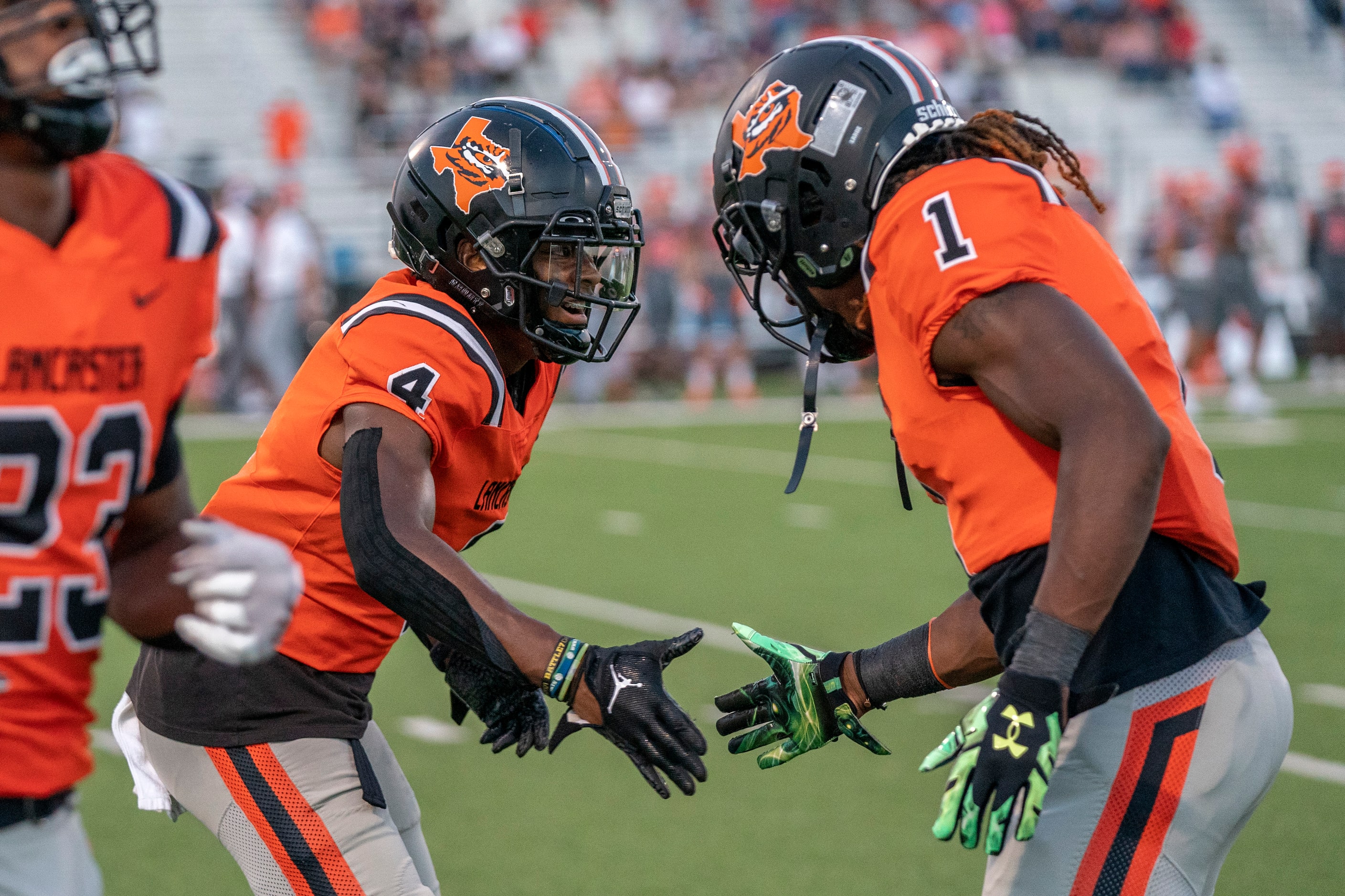 Lancaster senior defensive back Dwight Jones (4) celebrates with senior running back Kyson...